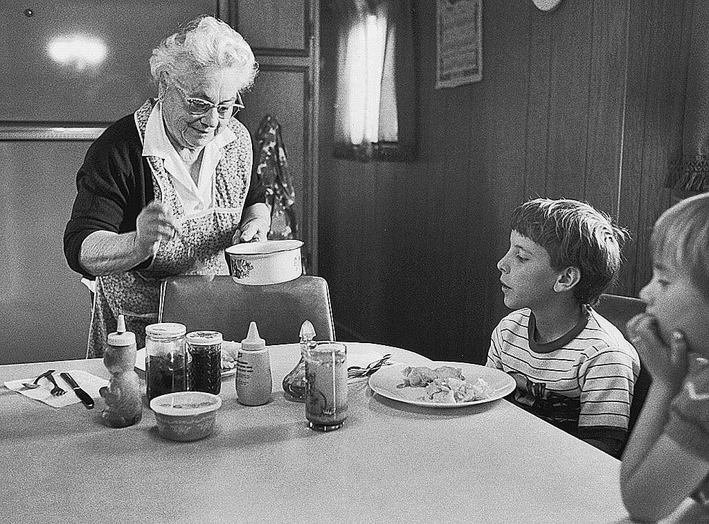 A grandmother serving dinner